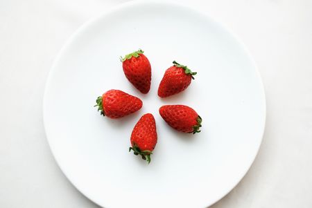 Star formation strawberry on white plateの写真素材
