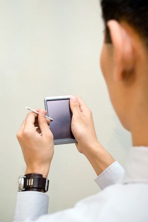 Business male looking at PDAの写真素材