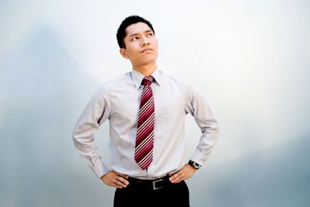 Asian male business looking upwards thinkingの写真素材