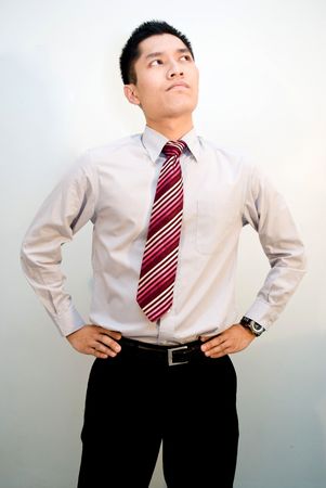 Asian male business looking upwards thinkingの写真素材