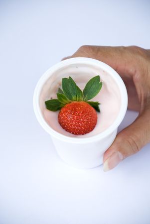Hand holding Strawberry in yogurt cupの写真素材