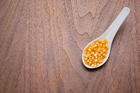 Corn kernel in spoonの写真素材