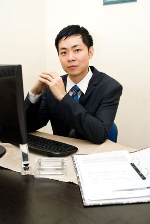 Asian business man at desk - seriousの写真素材