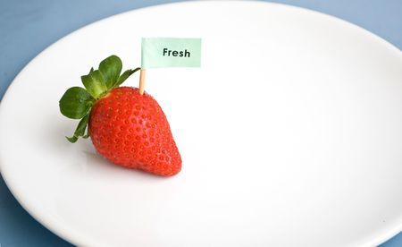 Strawberry with fresh sign on plateのeditorial素材