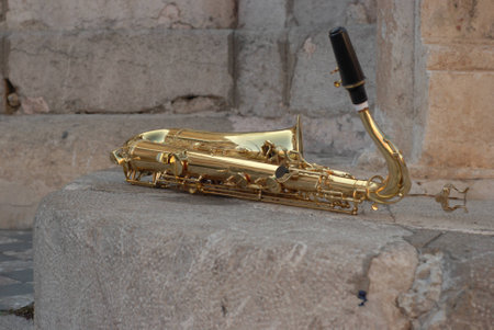 Golden saxophone on the rockの写真素材