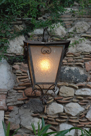 Old street lamp on the wallの写真素材