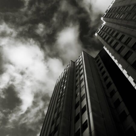 A block of apartment buildings with dramatic light