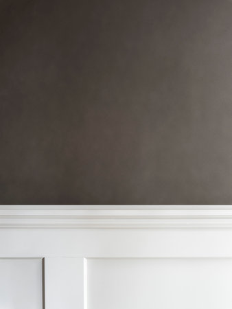 Close up of white chest of drawers in front of black wallの写真素材