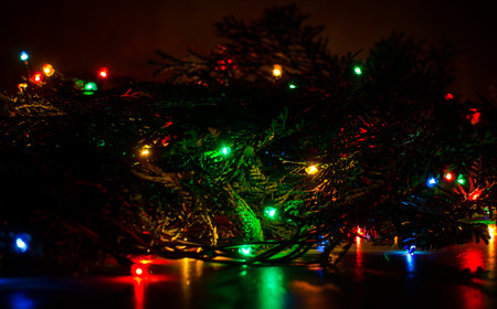 Christmas lights on a tree in different colors are classic symbol of Christmas.