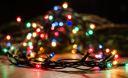 Christmas lights on a tree in different colors are classic symbol of Christmas.の写真素材
