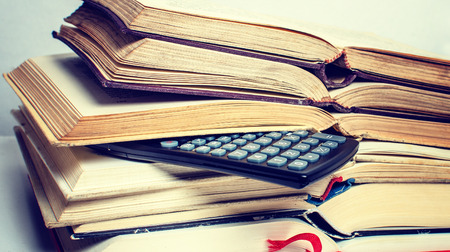 A  pile of books and a calculator help in learning.