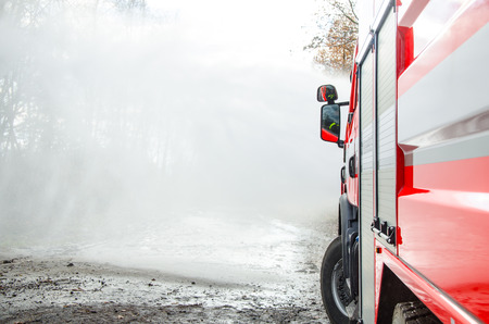 Firefighters with a hose to save property and life.