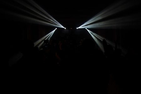 Young dancing people at the party in the shadow.