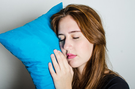Woman sleeping on a blue pillow.の写真素材
