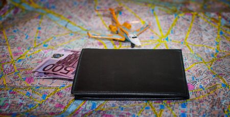 Money in the wallet on the map with the plane.の写真素材