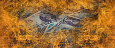 A one dollar bill in American US currency is on fire
