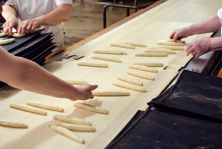 Working on a sweet pastry in a big industrial bakery.