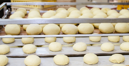 Preparation of donuts. Roasting in boiling oil. Cookng, fried.の写真素材