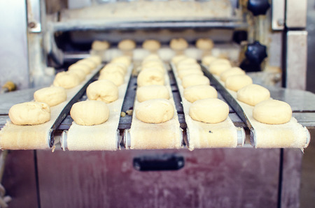 Working on a sweet pastry in a big industrial bakery.