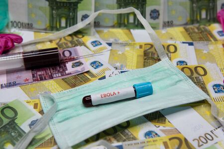 Euro money and tube with blood and positive test at Ebola.の写真素材