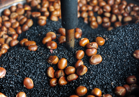 Movement of roasting chestnut potの写真素材
