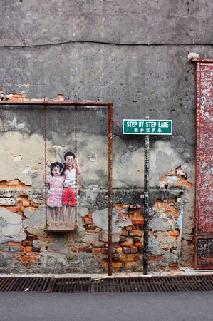 PENANG, MALAYSIA-MAY 12  Street Mural tittle  Children on the Swing  painted by Louis Gan in Penang on May 12, 2014  It was painted in conjunction with the 2012 George Town Festival のeditorial素材