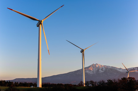 Wind turbines with mountainの写真素材