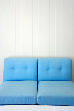 blue sofa on white wooden backgroundの写真素材