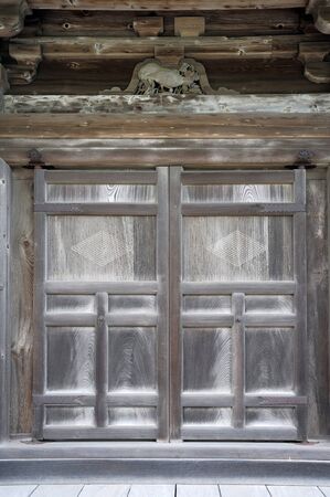 Old wooden door in The Japanese shrineの写真素材