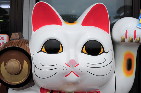 Maneki Neko cat. Common Japanese sculpture bring good luck to the owner.の写真素材