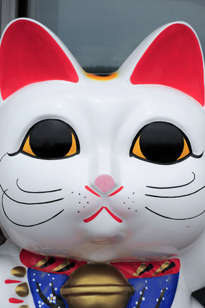 Maneki Neko cat. Common Japanese sculpture bring good luck to the owner.の写真素材
