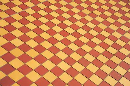 Ceramic orange and yellow tile mosaic on floor  tile mosaic on floor  with shallow depth of fieldの写真素材