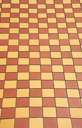 Ceramic orange and yellow tile mosaic on floorの写真素材