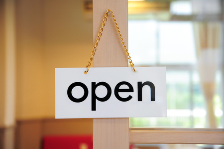 open signboard on a door at coffee shopの写真素材