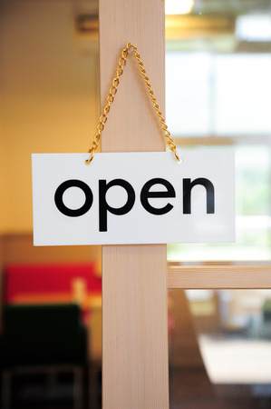 open signboard on a door at coffee shopの写真素材