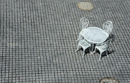 White metal bench on stone texture tileの写真素材