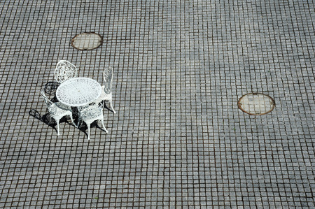 White metal bench on stone texture tileの写真素材