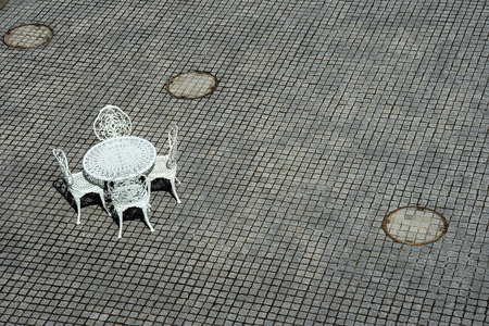 White metal bench on stone texture tileの写真素材