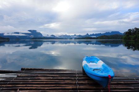 Blue Kayak on Morning after rain in  a beautiful mountains lake forest and river natural attractions in Ratchaprapha Dam at Khao Sok National Park, Surat Thani Province, Thailand.の写真素材