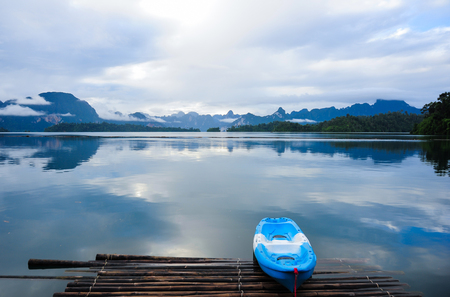 Blue Kayak on Morning after rain in  a beautiful mountains lake forest and river natural attractions in Ratchaprapha Dam at Khao Sok National Park, Surat Thani Province, Thailand.の写真素材