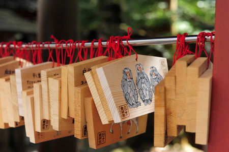 NIKKO, JAPAN - OCTOBER 6,Wooden plate of Three wise monkey in Toshogu shrine Nikko, Japan on October 6, 2015. Shrine visitors write their wishes on wood plates and leave them inside the Toshogu shrine in the hope that their wishes come true.のeditorial素材