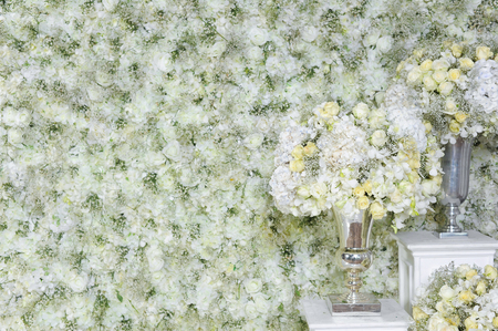 White roses in a vase and white roses wallの写真素材