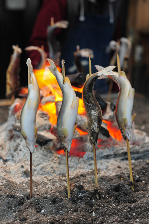 Fish Ayu with salt being grilled in Japan , Japanese grill styleの写真素材