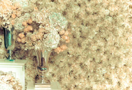 White roses in a vase and white roses wall - vintage toneの写真素材