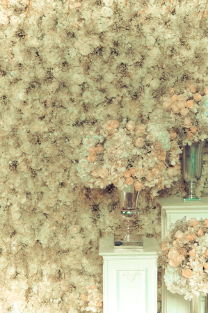 White roses in a vase and white roses wall - vintage toneの写真素材