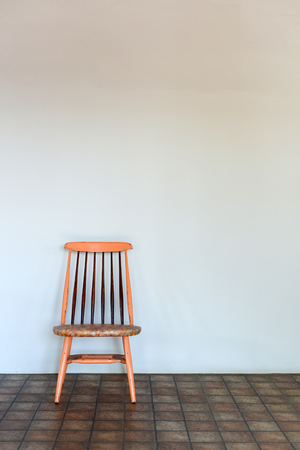 Wooden chair with white wallの写真素材