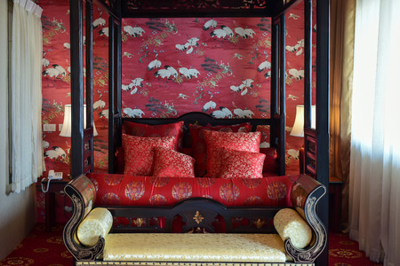 Red decorated bed in Chinese style set for the bride and the groom.の写真素材