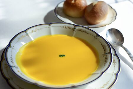 Pumpkin cream soup with breadの写真素材