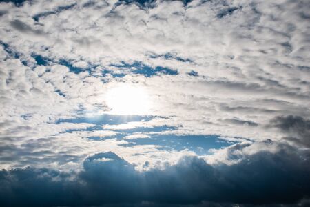 the suns rays shine through the clouds. cloudy sky, backgroundの写真素材