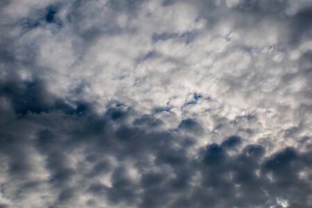 gray clouds of tangles in the blue sky, background
